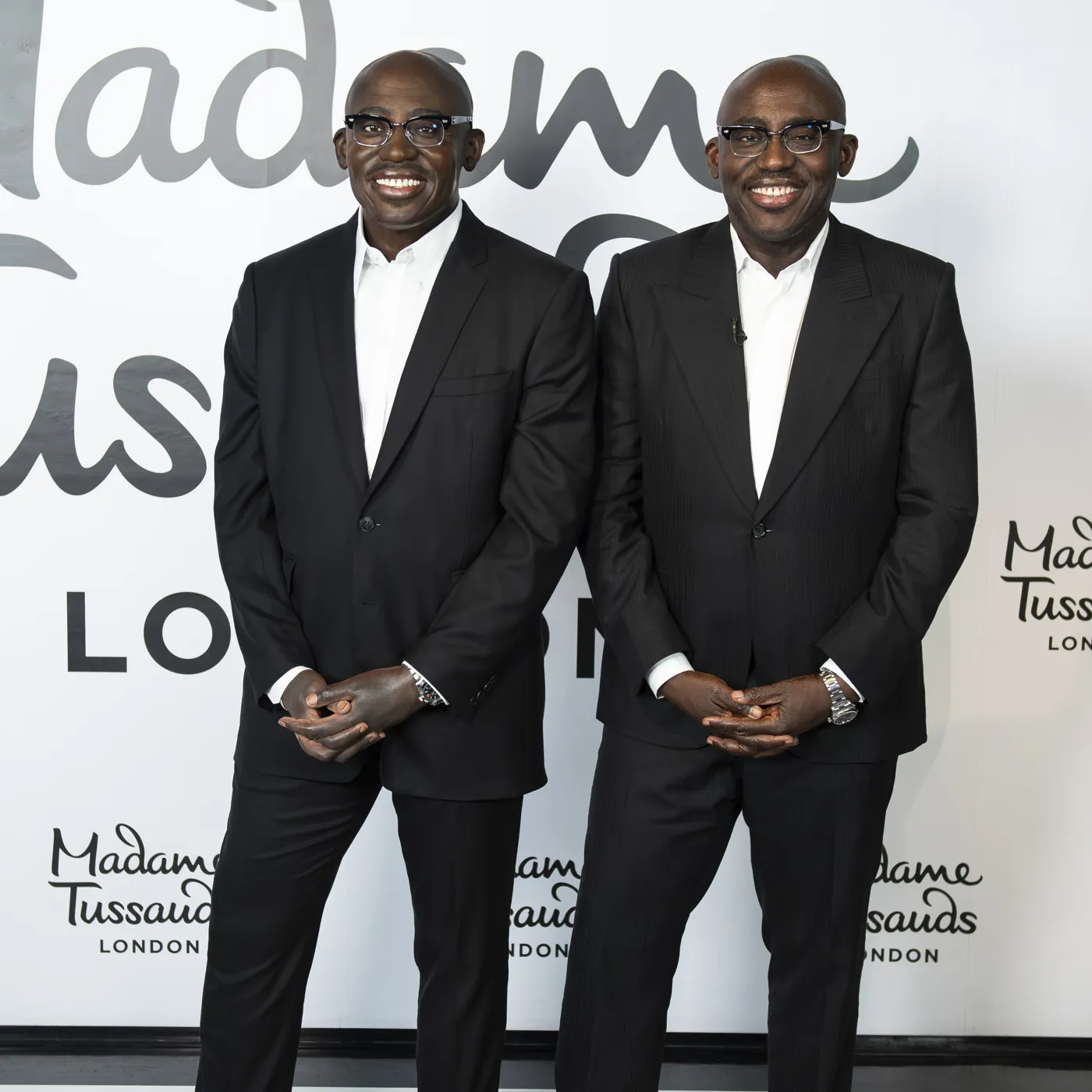 Edward Enninful standing next to his figure at Madame Tussauds London